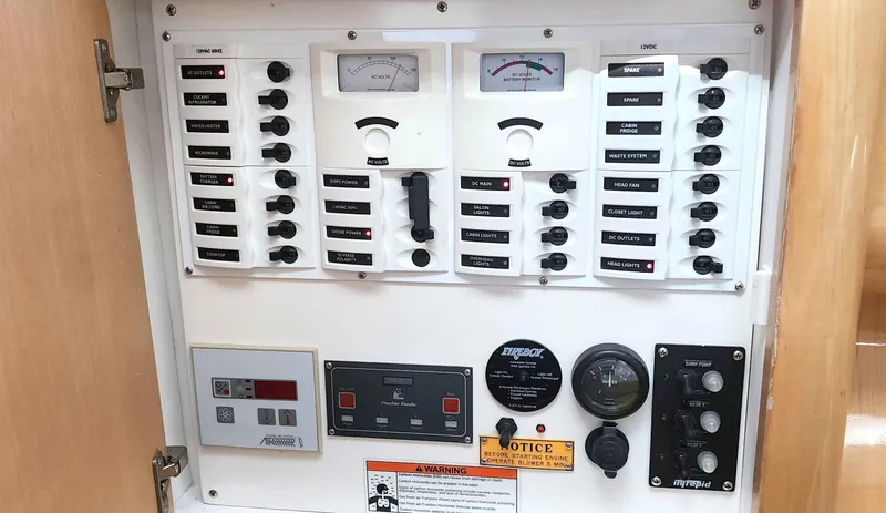 Slide: The Image of Electrical control panel of a 2008 Intrepid 430 Sport Yacht with various switches and gauges. - 39