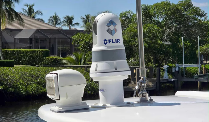 Slide: The Image of FLIR camera on 2008 Intrepid 430 Sport Yacht, docked near lush greenery. - 4