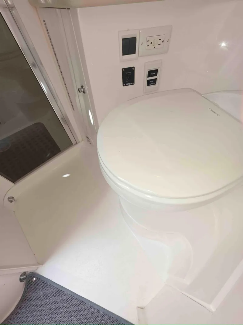 Slide: The Image of 2008 Intrepid 430 Sport Yacht bathroom with modern toilet and control panel. - 47