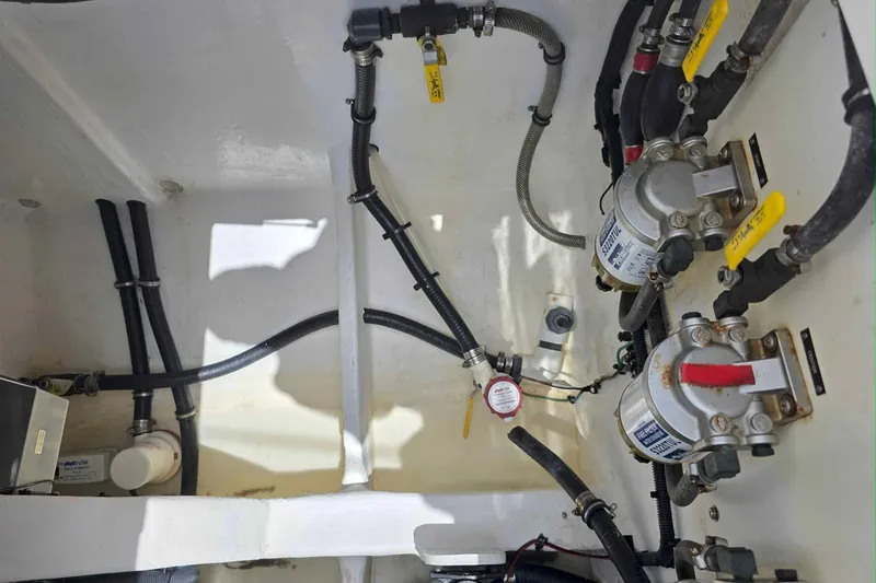 Slide: The Image of Engine compartment of a 2008 Intrepid 430 Sport Yacht, showcasing fuel filters and hoses. - 49