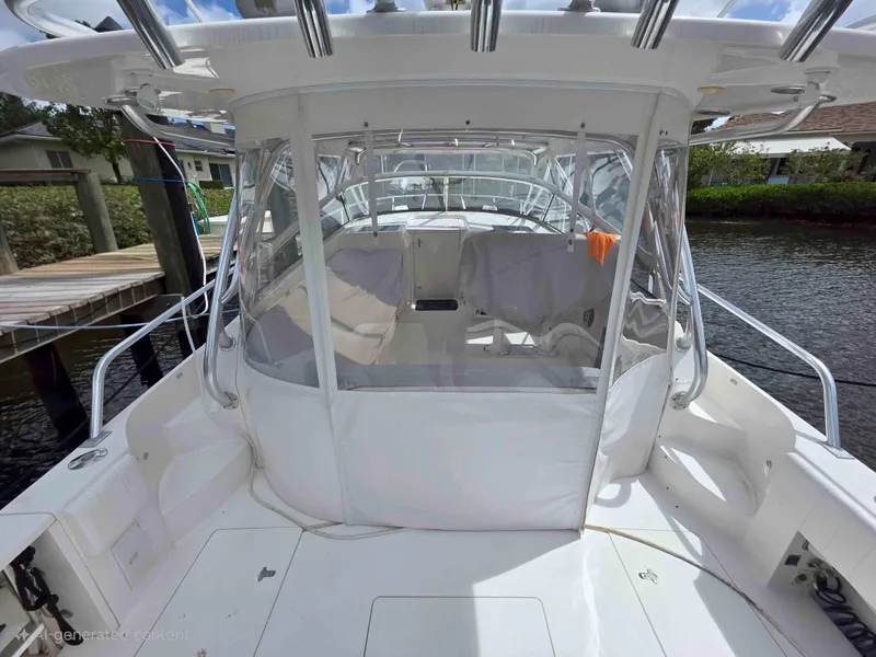 Slide: The Image of 2008 Intrepid 430 Sport Yacht docked, featuring spacious cockpit and clear enclosure. - 5
