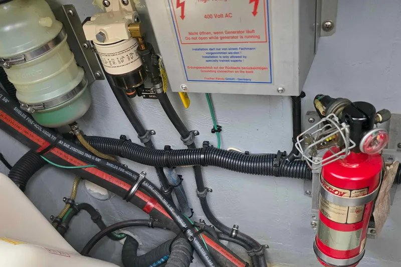 Slide: The Image of Engine room of 2008 Intrepid 430 Sport Yacht with fire extinguisher and electrical components. - 51