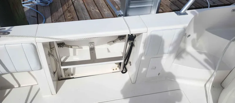 Slide: The Image of 2008 Intrepid 430 Sport Yacht deck with open storage compartment and clean white finish. - 6