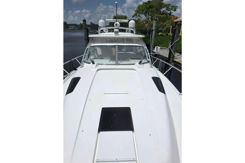 Slide: The Image of 2008 Intrepid 430 Sport Yacht docked, showcasing sleek design and advanced navigation equipment. - 60