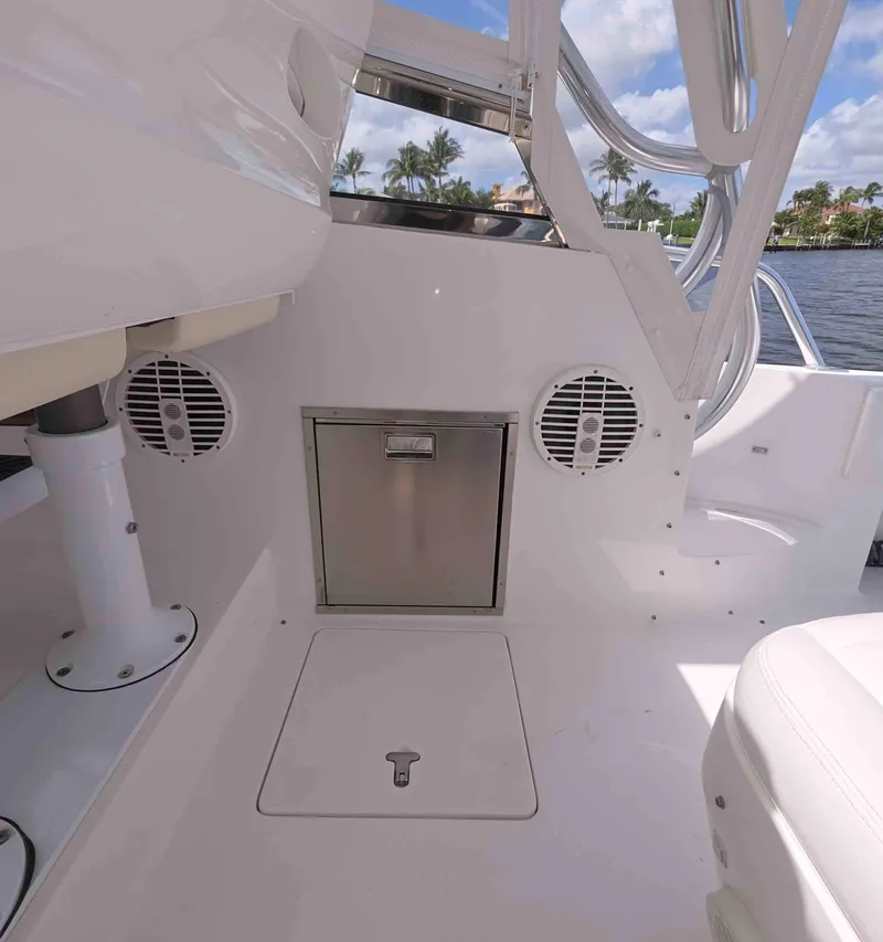 Slide: The Image of 2008 Intrepid 430 Sport Yacht interior with speakers and storage, featuring sleek white design. - 7