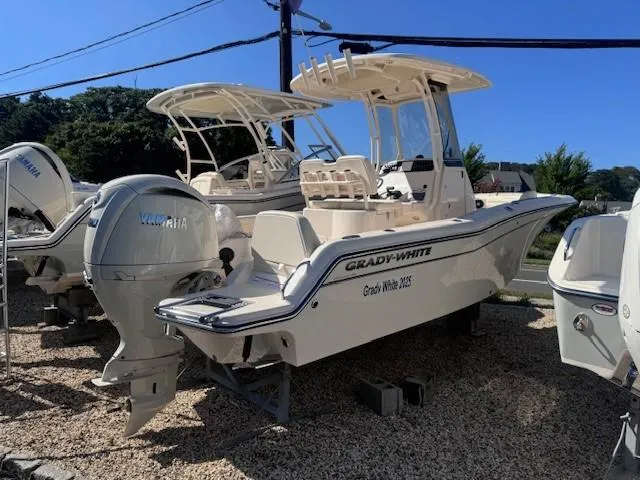 Slide: The Image of 2025 Grady-White 216 Fisherman boat with Yamaha engine, displayed outdoors. - 0