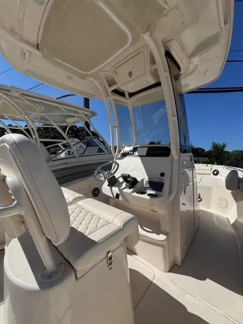 Slide: The Image of 2025 Grady-White 216 Fisherman boat interior with helm and seating. - 1