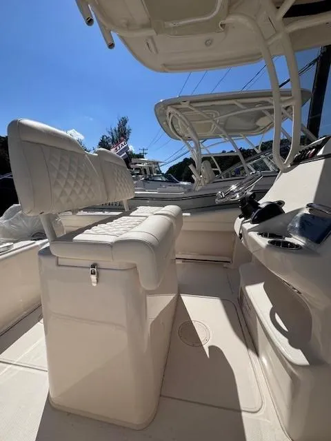 Slide: The Image of 2025 Grady-White 216 Fisherman boat interior with cushioned seating and helm controls. - 2