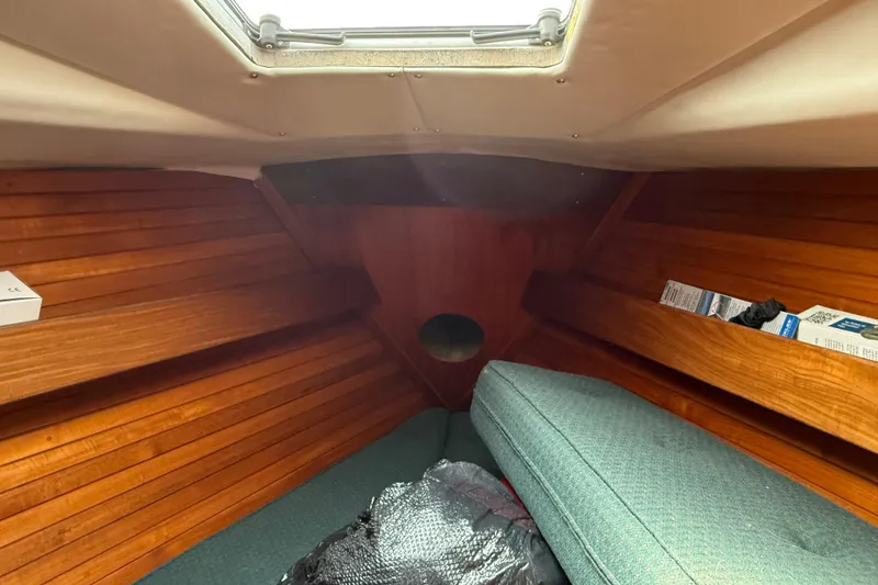 Slide: The Image of Interior cabin of 1985 Beneteau First 375 sailboat with wooden paneling and cushioned seating. - 17