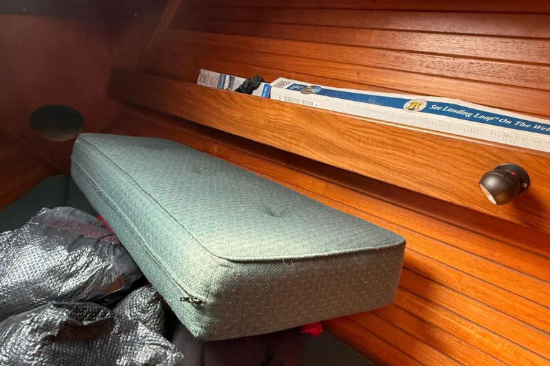 Slide: The Image of Interior of 1985 Beneteau First 375 sailboat with wooden paneling and cushioned seating. - 18