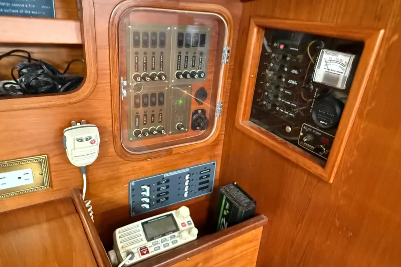 Slide: The Image of Electrical panel of a 1985 Beneteau First 375 sailboat, featuring control switches and meters. - 21