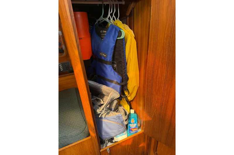 Slide: The Image of Storage closet on 1985 Beneteau First 375 with life jackets and sailing gear. - 22