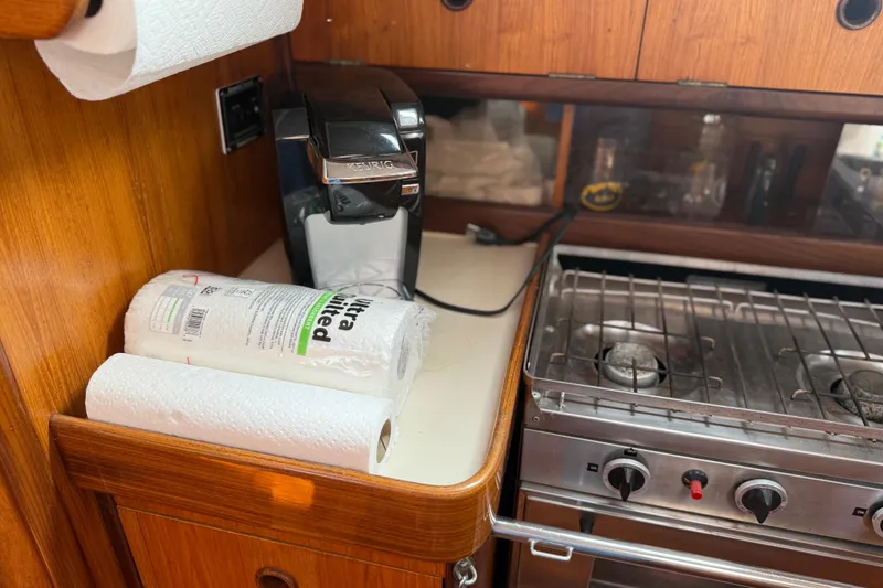 Slide: The Image of Galley of 1985 Beneteau First 375 with stove, Keurig, and paper towels. - 24