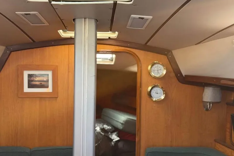 Slide: The Image of Interior of 1985 Beneteau First 375 sailboat with wood paneling and nautical instruments. - 29