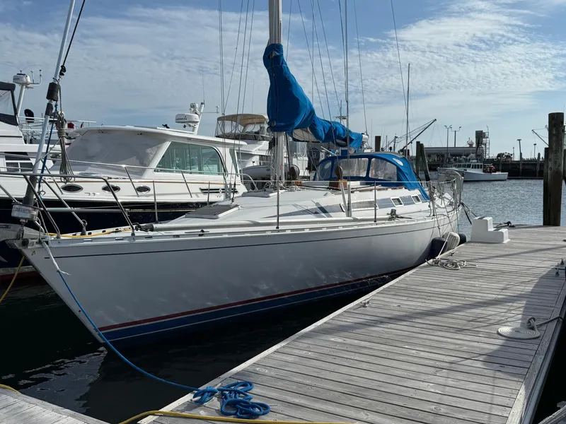 Slide: The Image of 1985 Beneteau First 375 sailboat docked at marina under clear sky. - 5