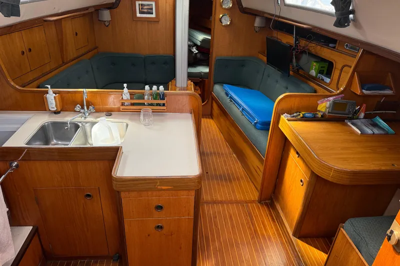 Slide: The Image of Interior of 1985 Beneteau First 375 sailboat with wood finish and cozy seating area. - 8
