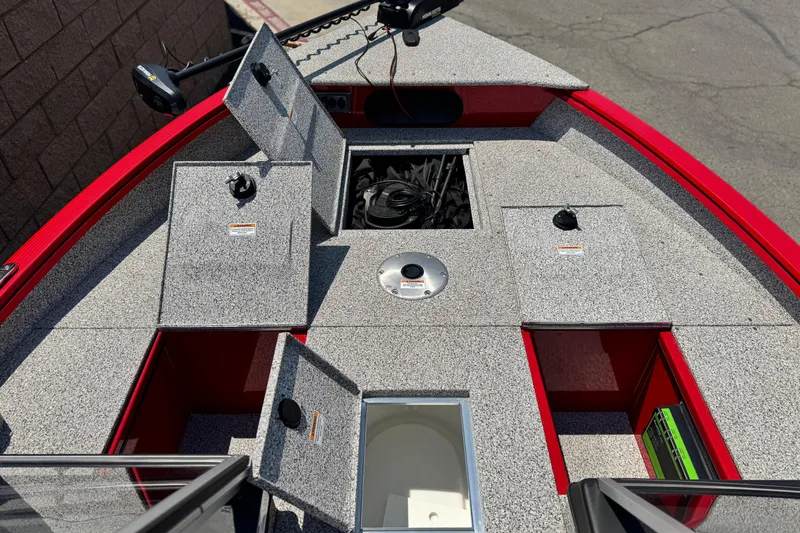 Slide: The Image of Red Apex Outlander V2010 boat deck with open storage compartments, 2024 model. - 10