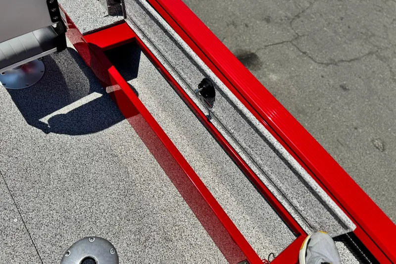 Slide: The Image of Red and gray interior of 2024 Apex Outlander V2010 boat, featuring textured flooring. - 14