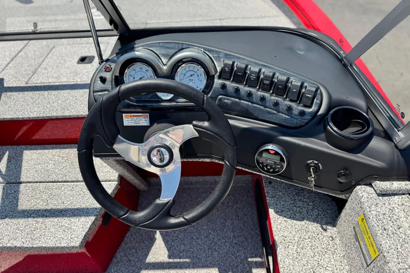 Slide: The Image of Steering console of 2024 Apex Outlander V2010 boat with gauges and controls. - 18