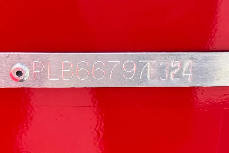 Slide: The Image of Metallic plate with engraved code "PLB66797E324" on red Apex Outlander V2010, 2024 model. - 20