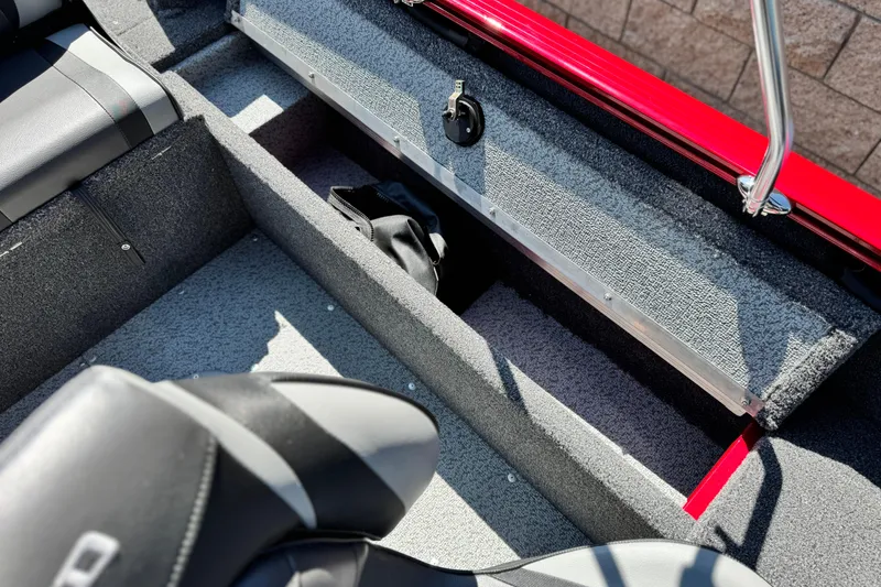 Slide: The Image of 2024 Lund 1650 Rebel XL Sport boat interior with open storage compartment. - 15
