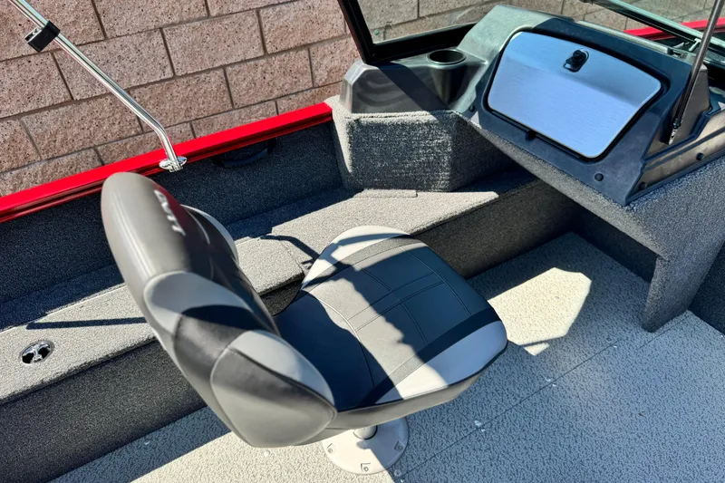 Slide: The Image of 2024 Lund 1650 Rebel XL Sport boat interior with swivel seat and storage compartment. - 16