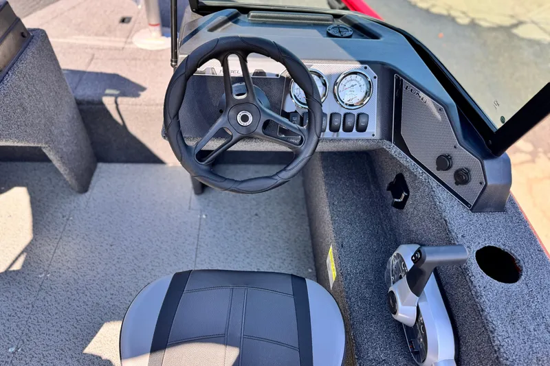 Slide: The Image of 2024 Lund 1650 Rebel XL Sport boat cockpit with steering wheel and control panel. - 18