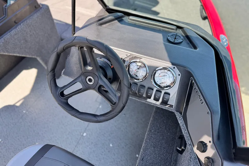 Slide: The Image of 2024 Lund 1650 Rebel XL Sport dashboard with steering wheel and gauges. - 19