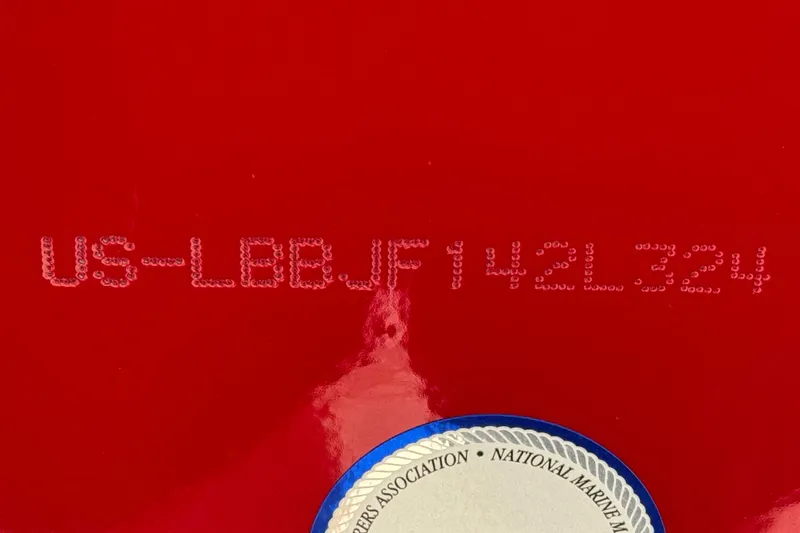 Slide: The Image of Red hull of 2024 Lund 1650 Rebel XL Sport with identification number and marine certification seal. - 21