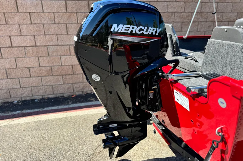 Slide: The Image of 2024 Lund 1650 Rebel XL Sport with Mercury outboard motor, red and black design. - 6