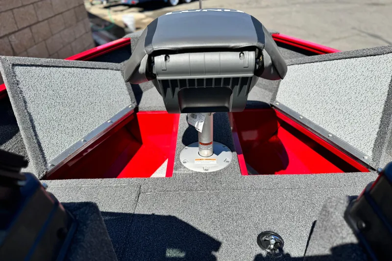 Slide: The Image of 2024 Lund 1650 Rebel XL Sport boat interior with storage compartments and seating. - 9