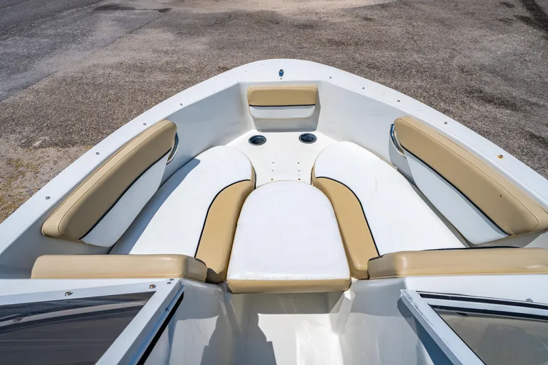 Slide: The Image of 2018 Caravelle 17 EBo Bowrider interior with beige seating and white deck. - 10