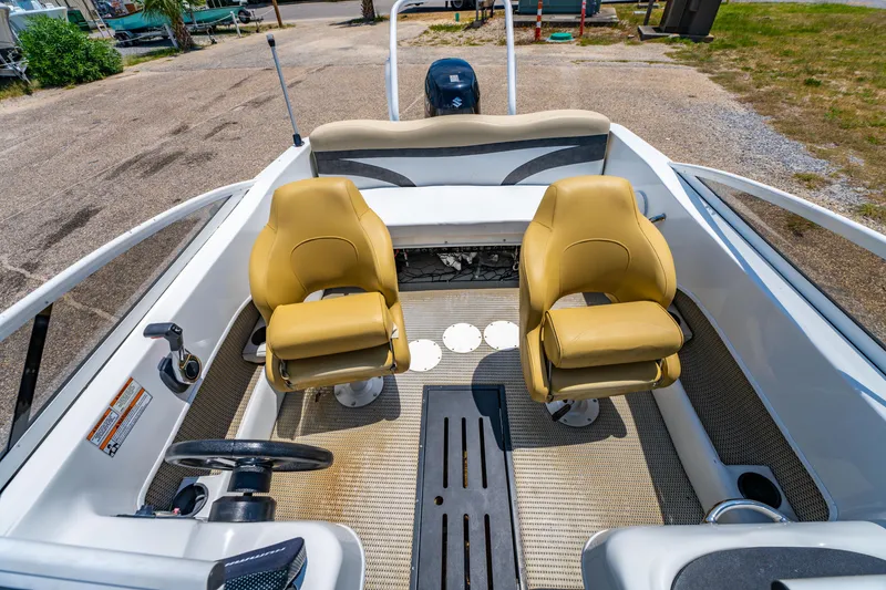 Slide: The Image of 2018 Caravelle 17 EBo Bowrider interior with two tan seats and steering wheel. - 11