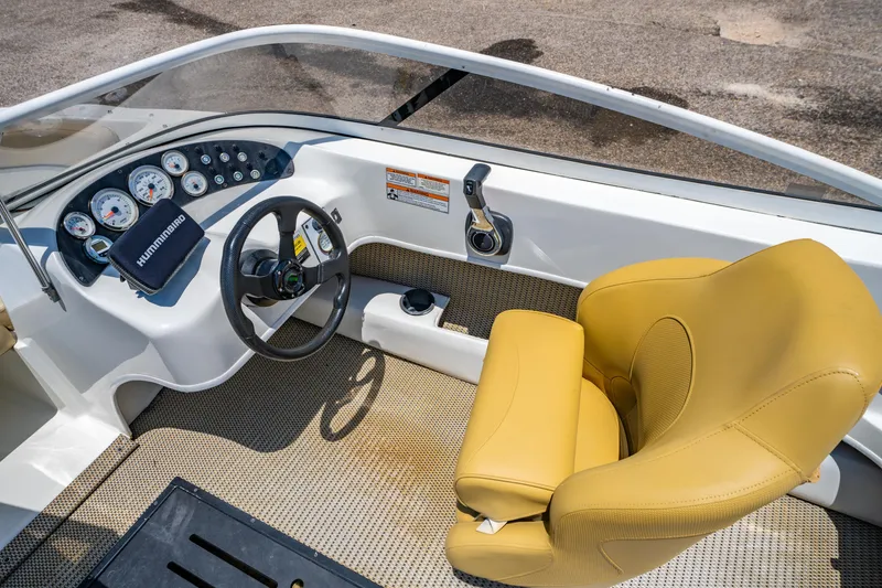 Slide: The Image of 2018 Caravelle 17 EBo Bowrider cockpit with yellow seat and steering wheel. - 12