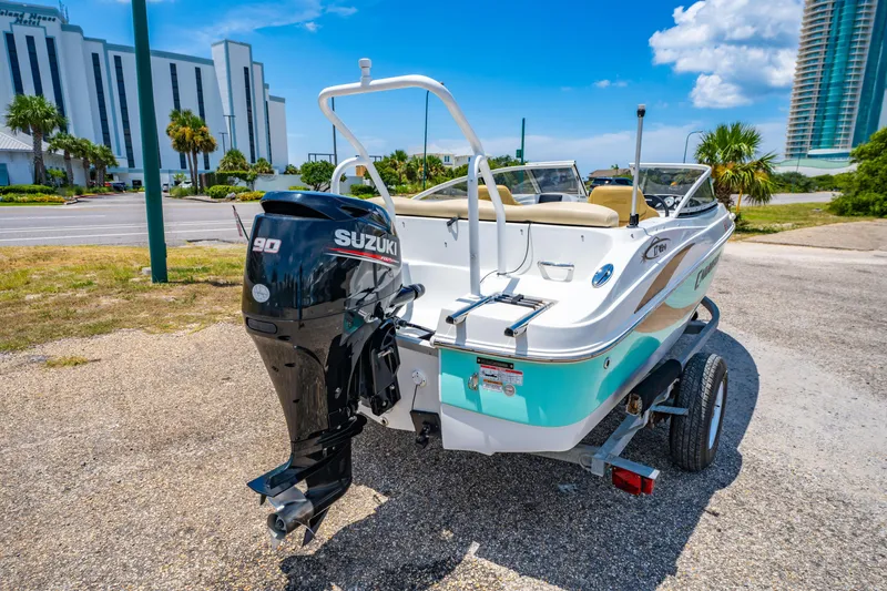 Slide: The Image of 2018 Caravelle 17 EBo Bowrider with Suzuki outboard motor on trailer, parked outdoors. - 3