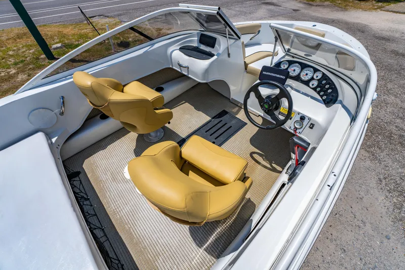 Slide: The Image of 2018 Caravelle 17 EBo Bowrider interior with tan seats and modern dashboard. - 8