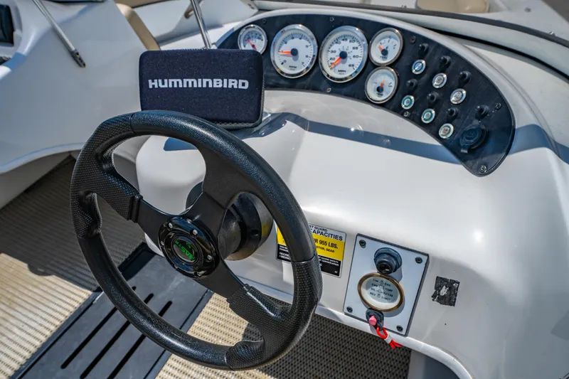 Slide: The Image of Steering wheel and dashboard of 2018 Caravelle 17 EBo Bowrider boat with gauges and controls. - 9