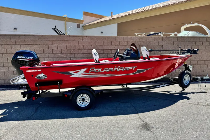 The Image of 2023 Apex Polar Kraft V186 boat, red exterior, on trailer, parked outdoors. - 1