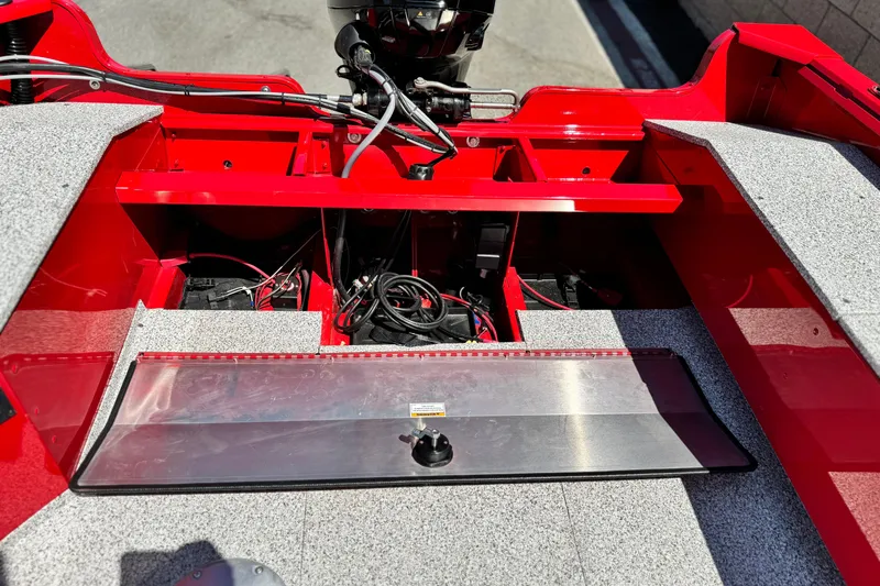 Slide: The Image of 2023 Apex Polar Kraft V186 boat interior with red and gray design, showcasing wiring and compartments. - 21