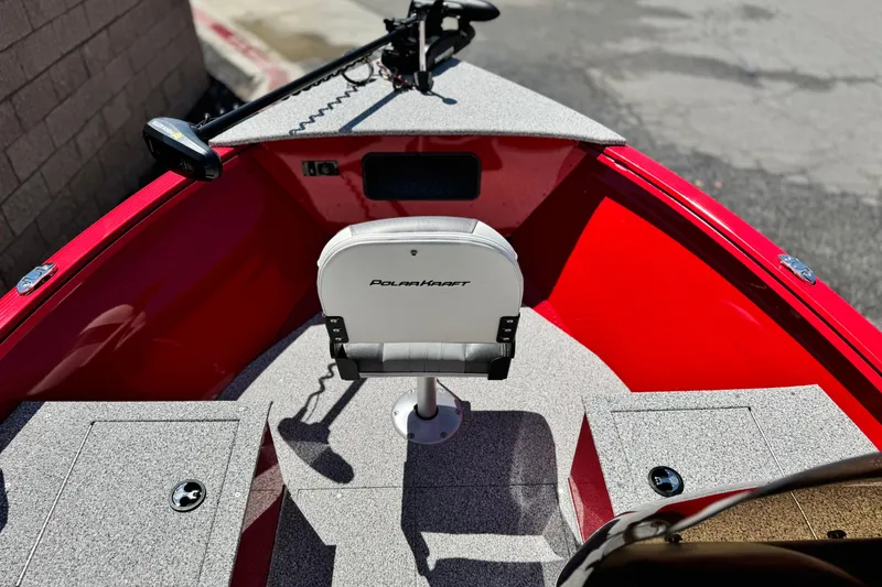 Slide: The Image of 2023 Apex Polar Kraft V186 boat interior with red accents and seating. - 12