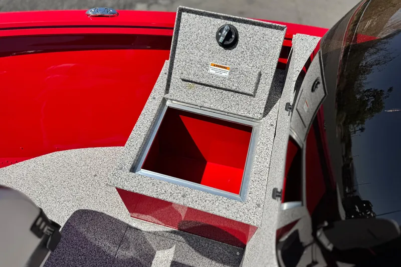 Slide: The Image of Open storage compartment on 2023 Apex Polar Kraft V186 boat, featuring red and gray interior. - 14