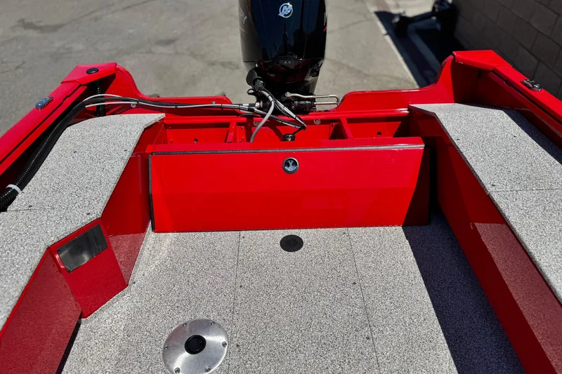 Slide: The Image of 2023 Apex Polar Kraft V186 boat interior with red accents and motor. - 20