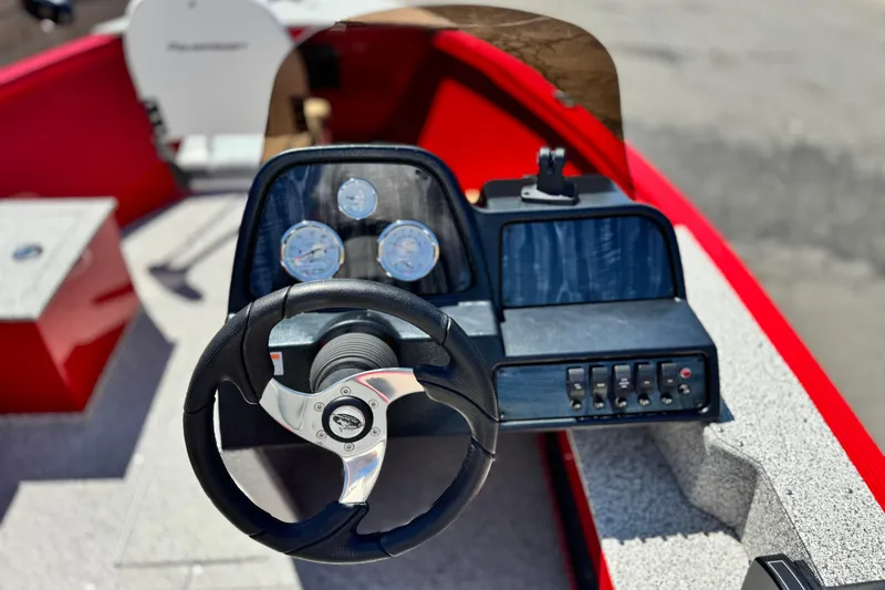 Slide: The Image of 2023 Apex Polar Kraft V186 boat dashboard with steering wheel and control panel. - 24