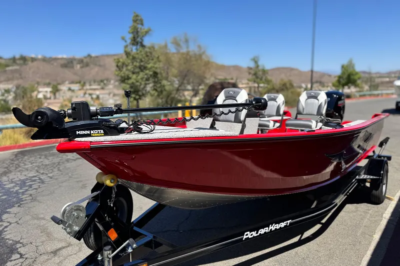 Slide: The Image of 2023 Apex Polar Kraft V186 boat with Minn Kota motor on trailer, sunny day. - 4