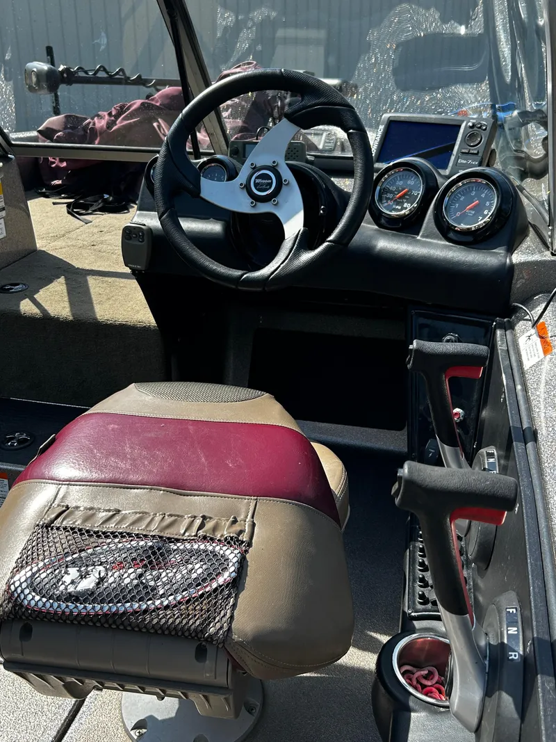 Slide: The Image of Interior of a 2013 Triton 186 Fishunter boat showing steering wheel and dashboard controls. - 3