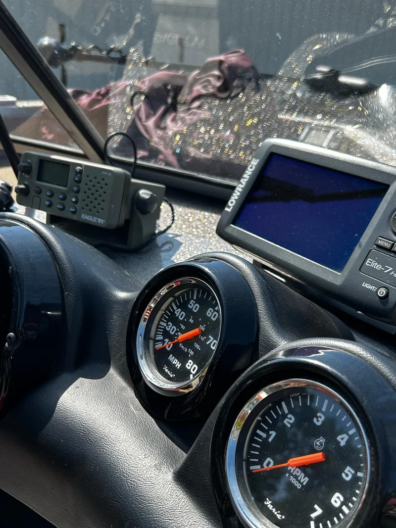 Slide: The Image of Dashboard of 2013 Triton 186 Fishunter with gauges and navigation equipment. - 4
