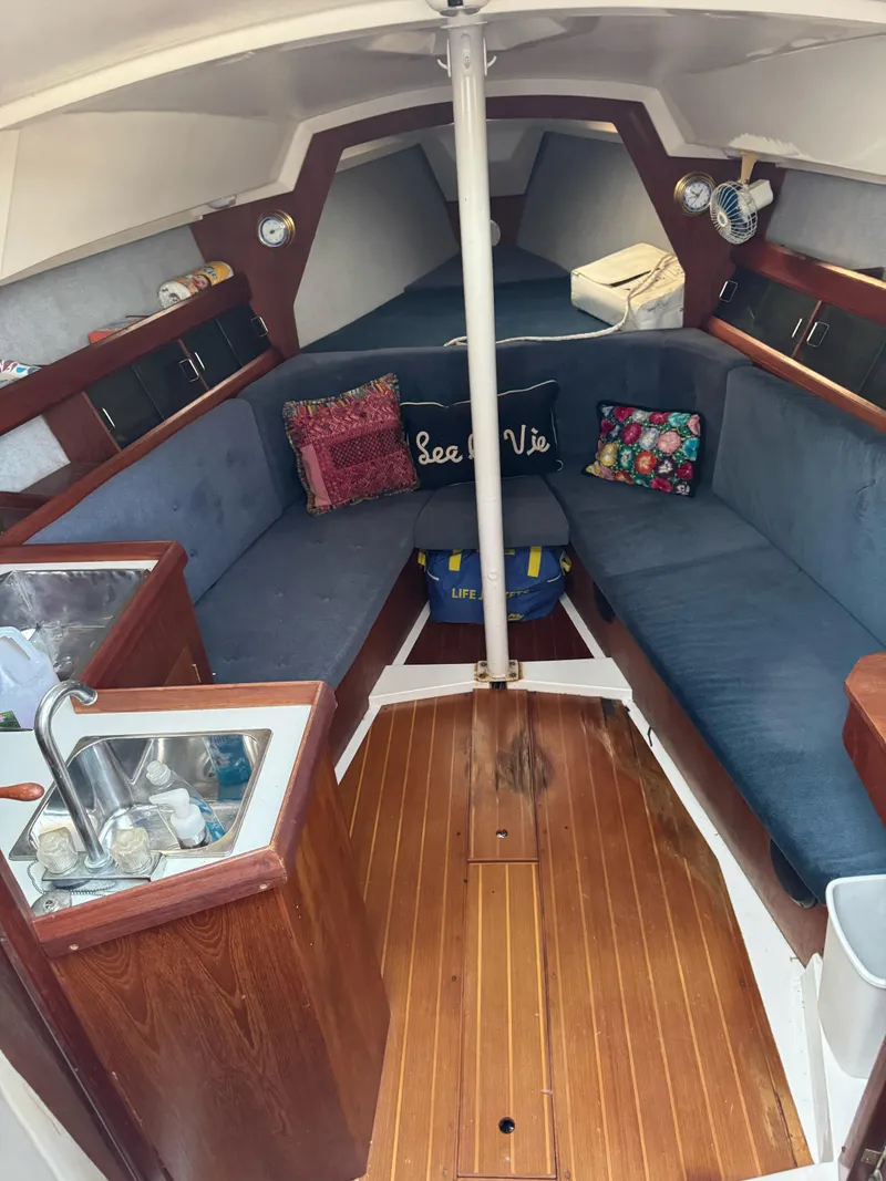 Slide: The Image of Interior of a 1986 Hunter 28.5 sailboat with cozy seating and wooden flooring. - 17