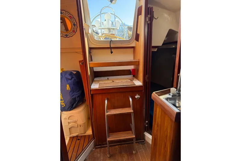 Slide: The Image of Interior of 1986 Hunter 28.5 sailboat with wooden cabinetry and compact design. - 24