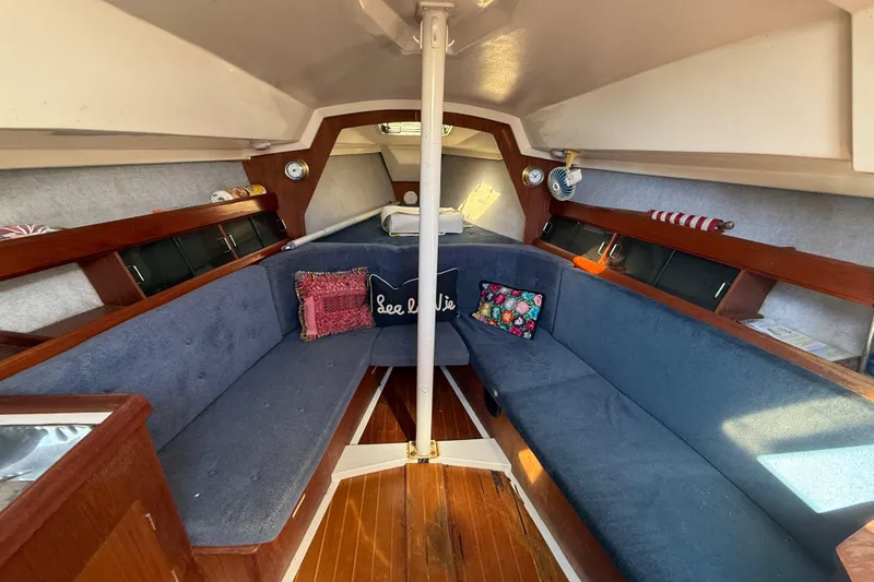 Slide: The Image of Interior of 1986 Hunter 28.5 sailboat with cozy seating and nautical decor. - 26