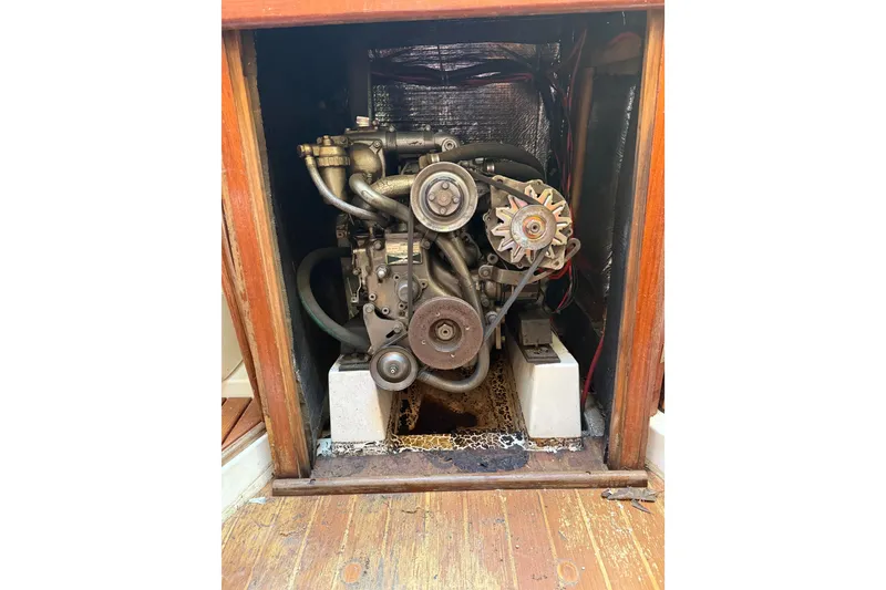 Slide: The Image of Engine compartment of a 1986 Hunter 28.5 sailboat, showcasing mechanical components. - 29